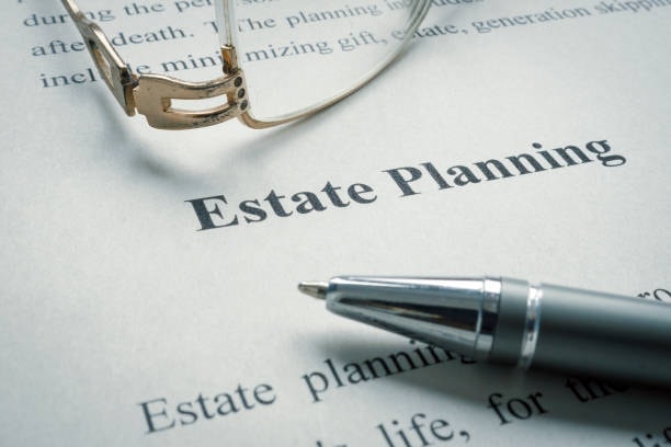 Estate planning documents with glasses and pen
